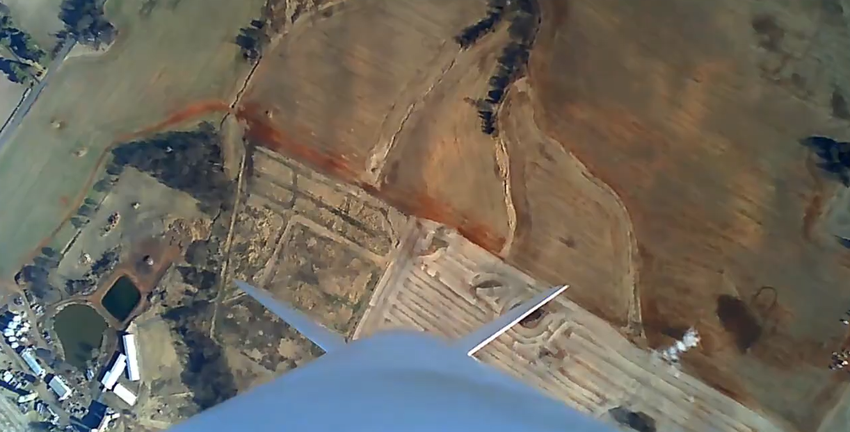 Aerial view looking down from an in-flight rocket over a launch site